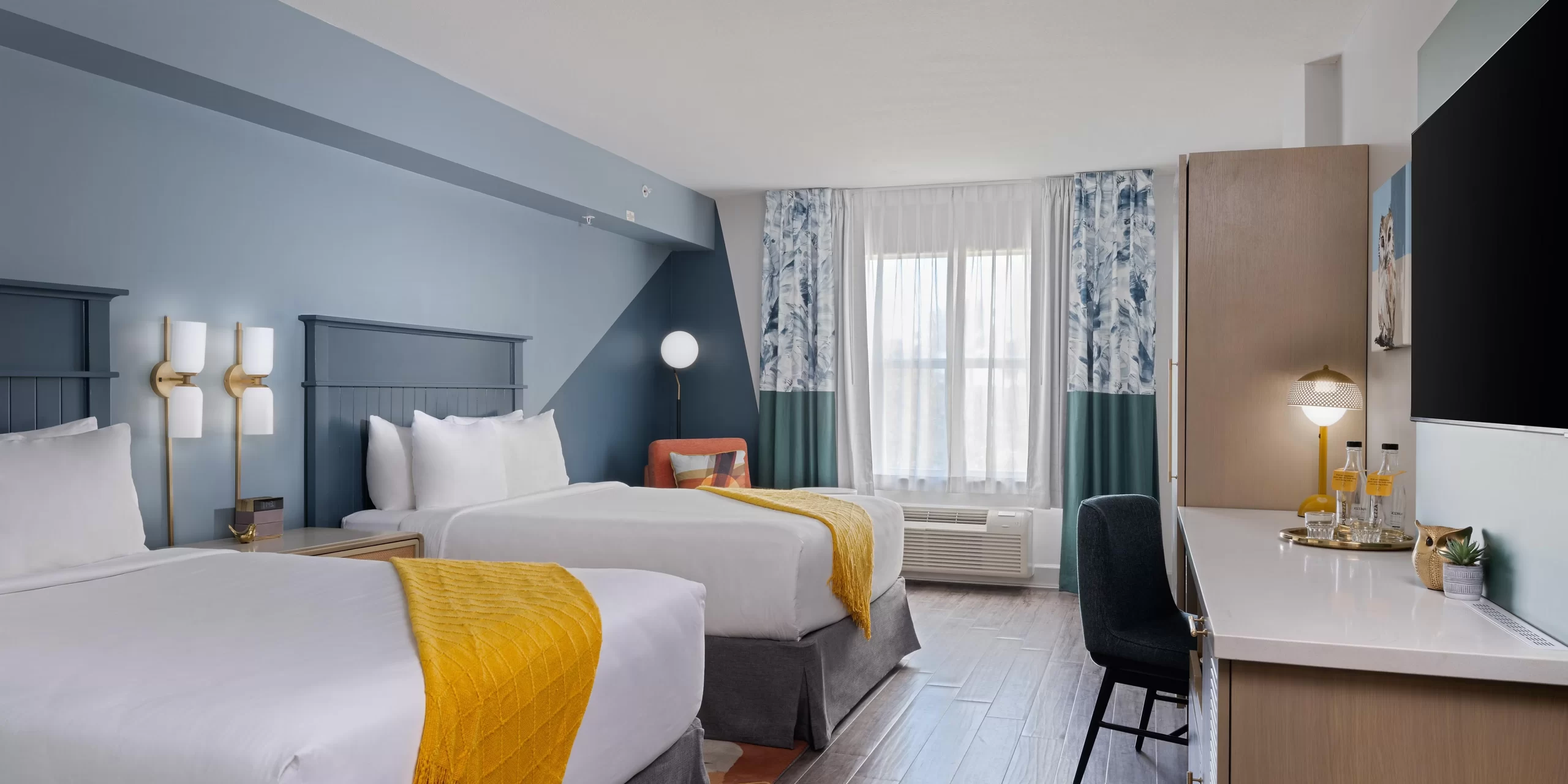 Completed hotel guest room with two beds and coordinated furnishings
